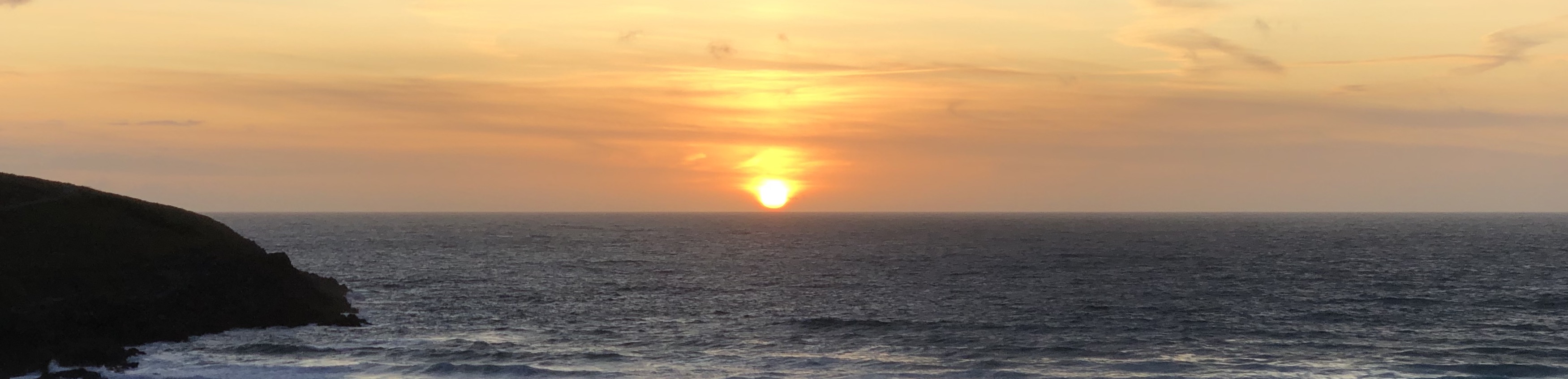 The sun setting over the sea